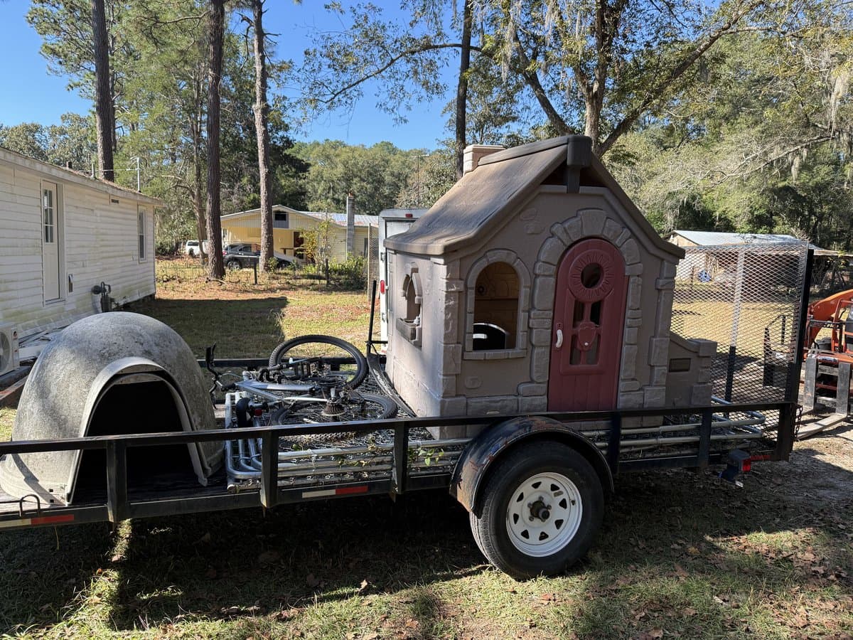 Playhouse and yard items loaded for removal